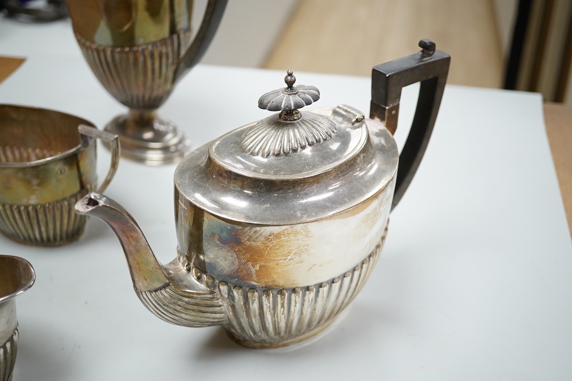 A George V demi fluted silver four piece oval tea set, comprising a teapot, hot water jug, cream jug and sugar bowl, Walker & Hall, 1910/11/12, gross weight 49oz.